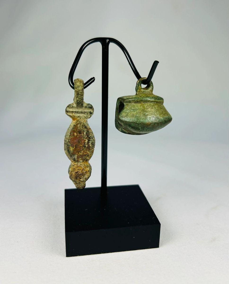 Front view of an Ancient Roman bronze pendant with suspension loop