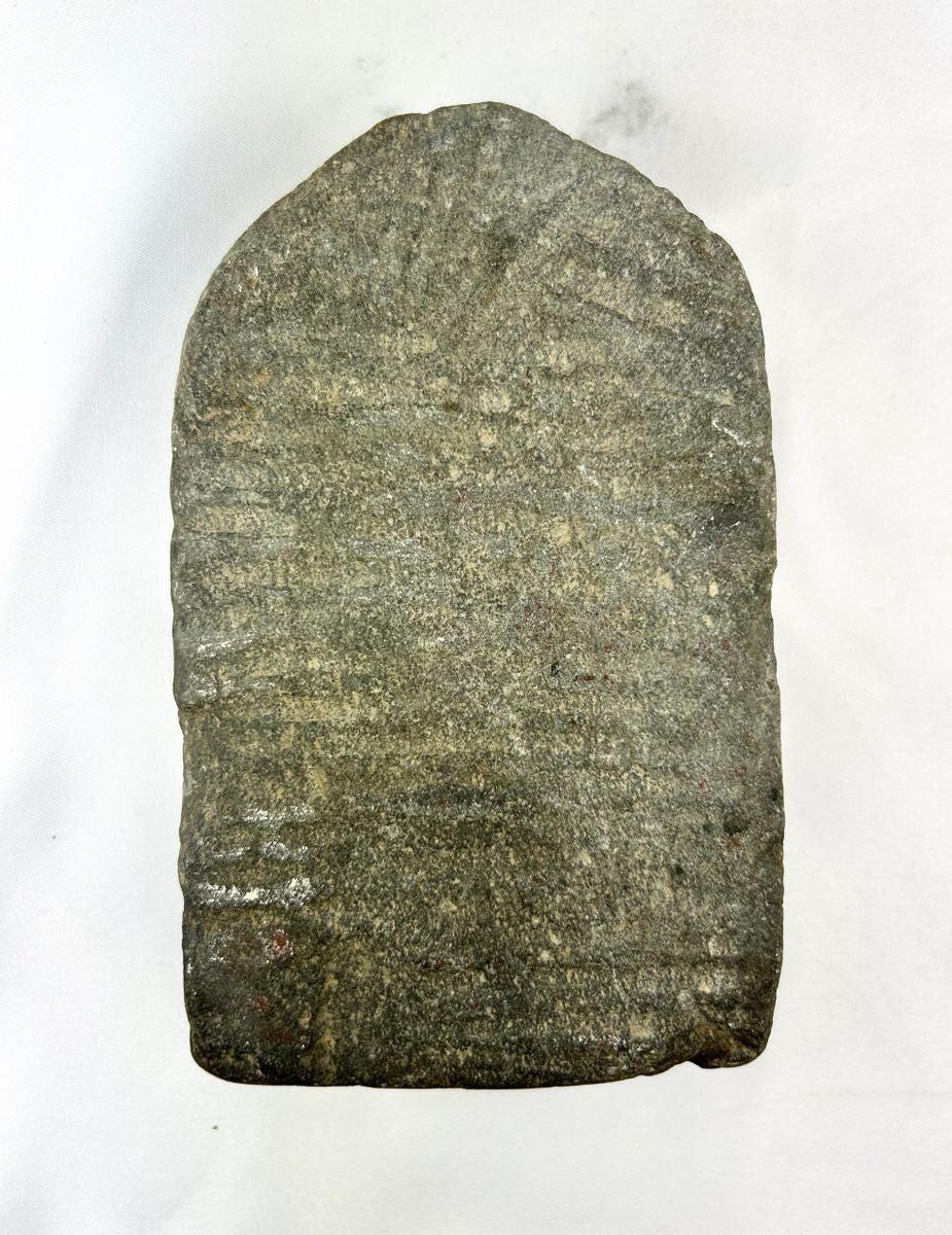 Rear view of a 14th-century Tibetan stone stele showing natural wear and carving marks