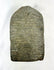Rear view of a 14th-century Tibetan stone stele showing natural wear and carving marks