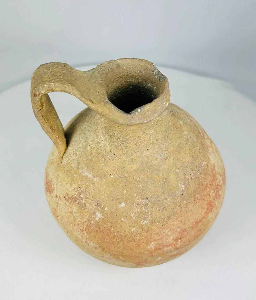 Terracotta jug from Abydos with arched handle and functional design