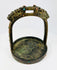 Side profile of Tibetan bronze stirrup with decorative gemstone settings and engraved details.
