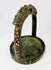 Museum-style presentation of Tibetan stirrup with mythical dragon motifs and gemstone inlay.