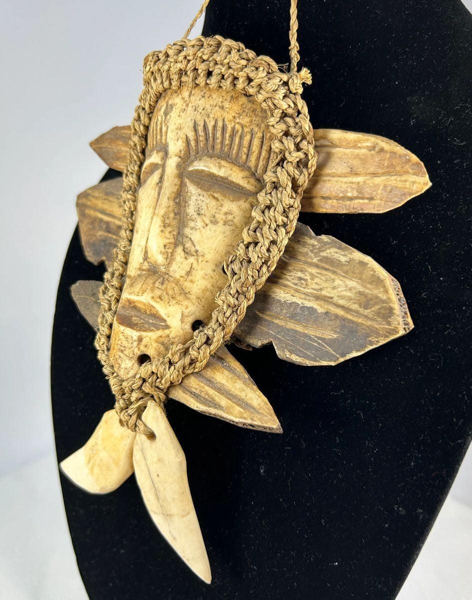 Lega tribal mask from Congo with bone face and braided fiber collar