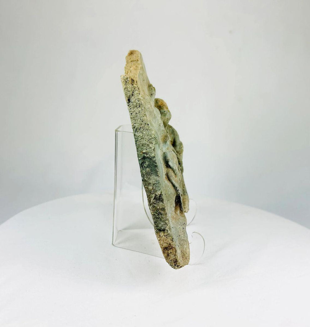 Classical Period limestone relief featuring two expressive human figures in mythological scene