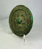 Han Dynasty circular bronze mirror with raised central knob and decorative carved motifs.