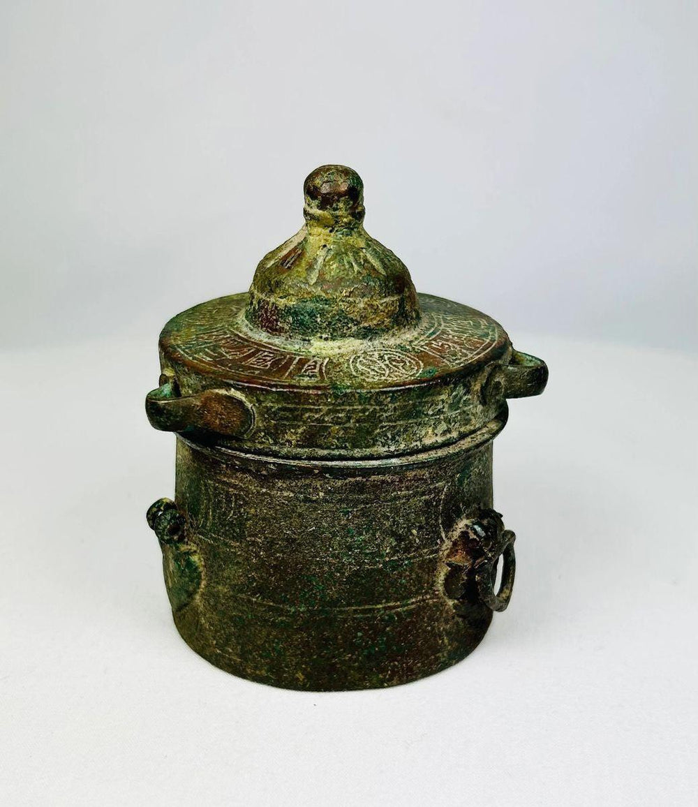 Close-up detail of engraved floral and geometric patterns on a Khorassan bronze inkwell