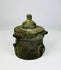 Close-up detail of engraved floral and geometric patterns on a Khorassan bronze inkwell