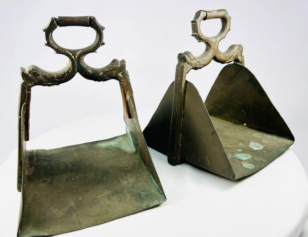 Antique pair of brass equestrian stirrups with triangular footrests