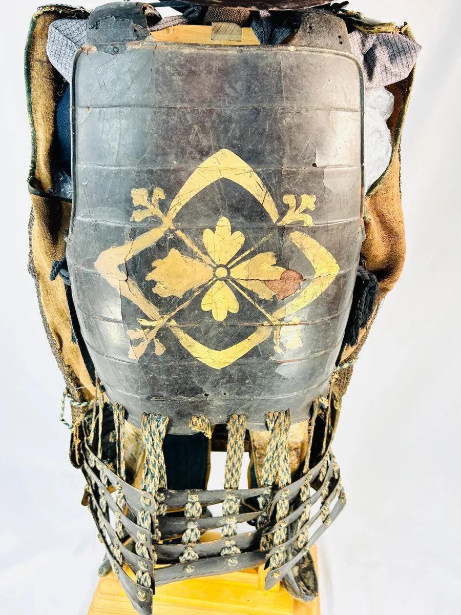 Gold-painted mon family crest on lacquered cuirass of authentic Muromachi Period samurai armor.