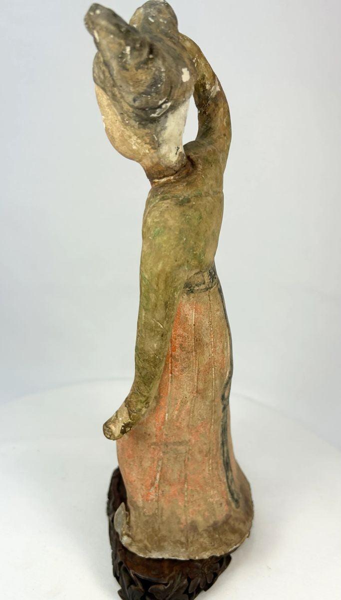 Low-fired terracotta Tang Dynasty funerary dancer with red-orange and black pigment traces