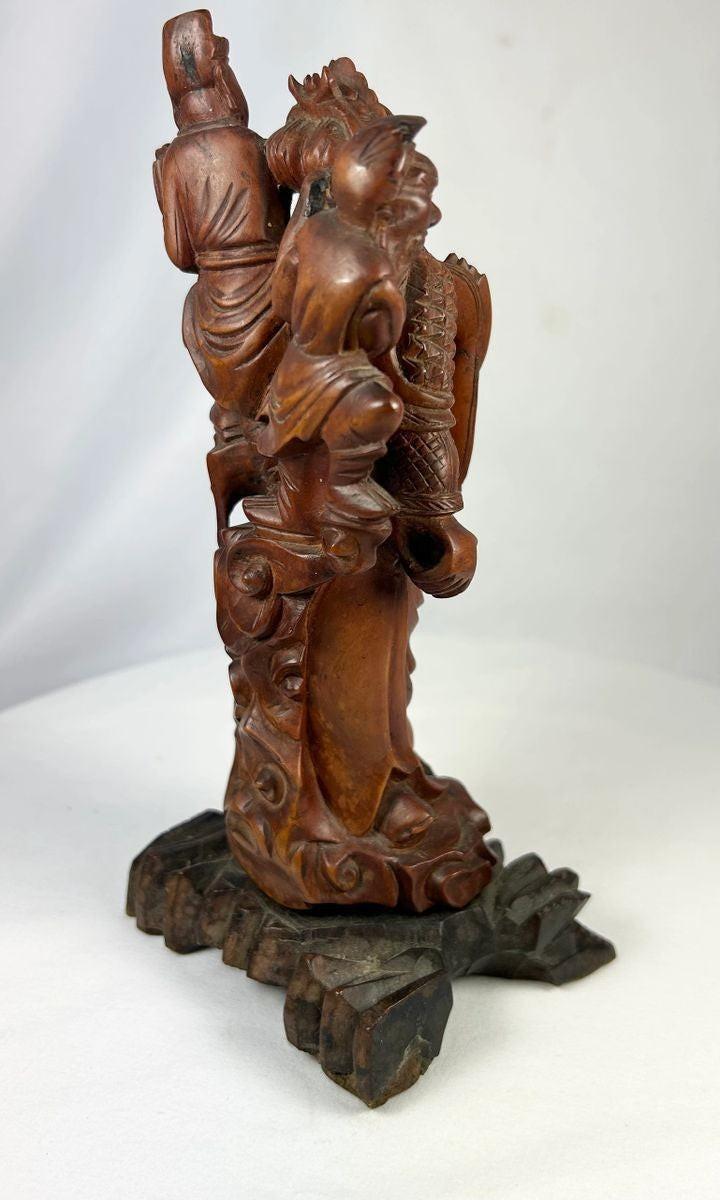 Qing Dynasty Chinese warrior immortal wood carving with dark polished patina