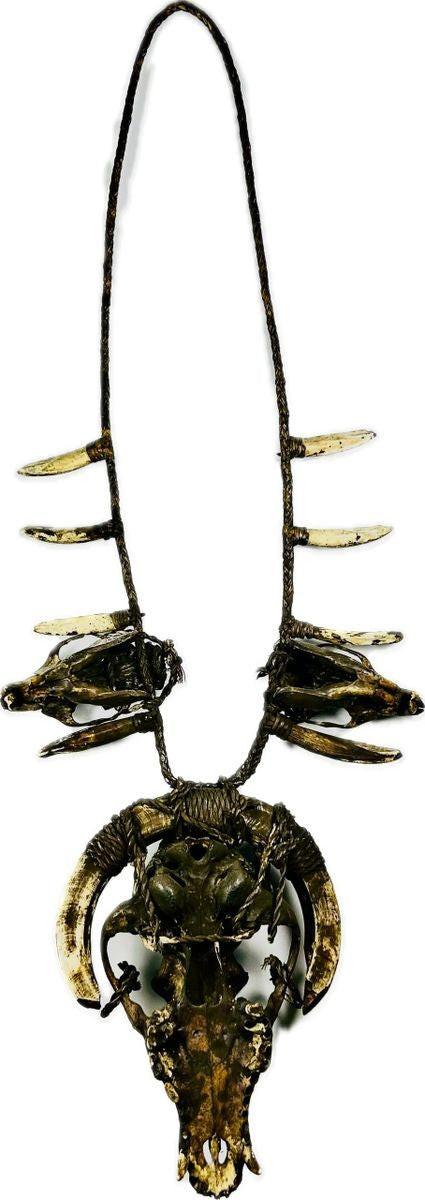 Ethnographic ceremonial necklace with central wild dog skull, flanked by rodent crania and radiating pig teeth