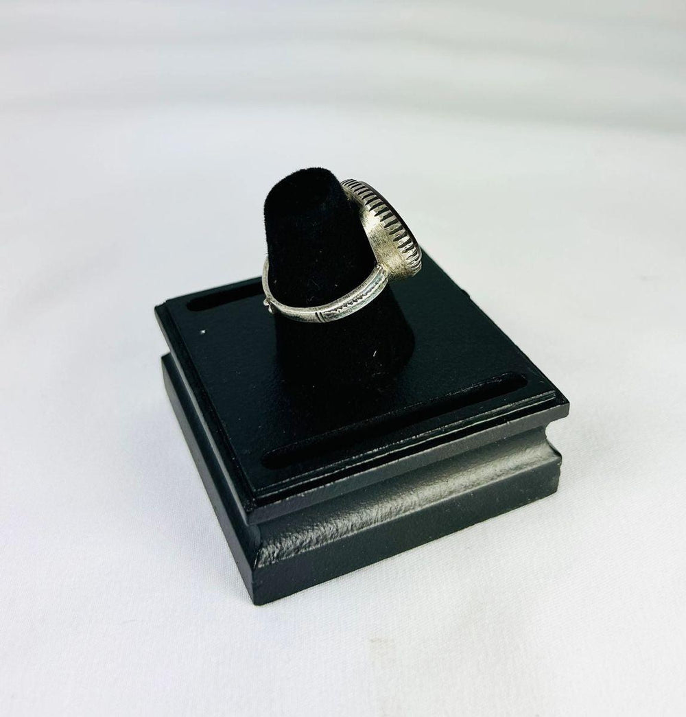 Oval red carnelian intaglio ring from Ancient Near East, 1st millennium BCE, detailed engravings, displayed on black stand