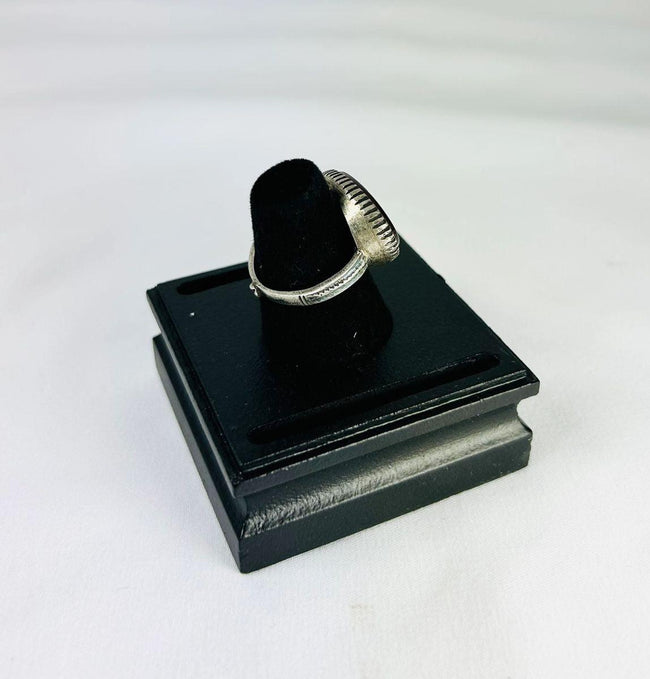 Oval red carnelian intaglio ring from Ancient Near East, 1st millennium BCE, detailed engravings, displayed on black stand