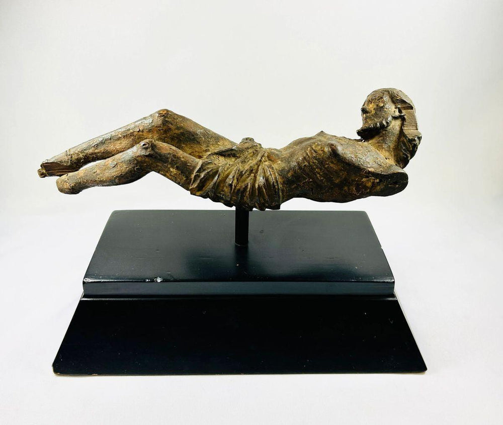 17th-century European wooden crucifix of Christ on a black display stand, showing detailed Baroque-era carving and aged patina — Relic & Rarity.