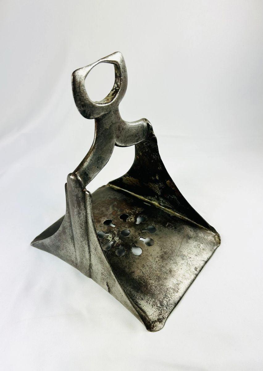 Side view of forged steel Ottoman stirrup highlighting surface aging and craftsmanship, 1600s.