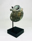 Detailed photograph of Roman bronze pendant featuring military or religious imagery.