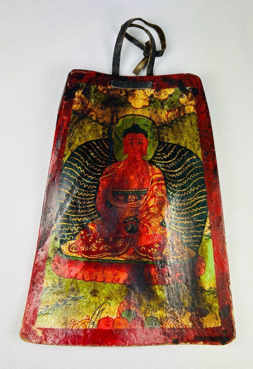 Front view of a 19th-century Tibetan Buddhist bone amulet with hand-painted polychrome details