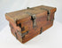 Antique wooden merchant lockbox with perforated iron hasp plate and aged surface wear.