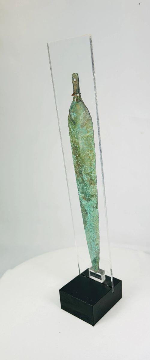 Museum-style image of an ancient bronze dagger blade from Western Asia