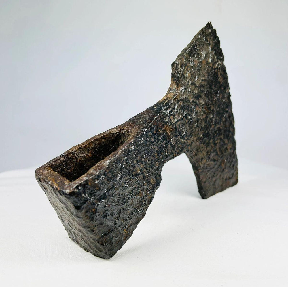 Medieval iron axe head featuring bearded blade and historic craftsmanship