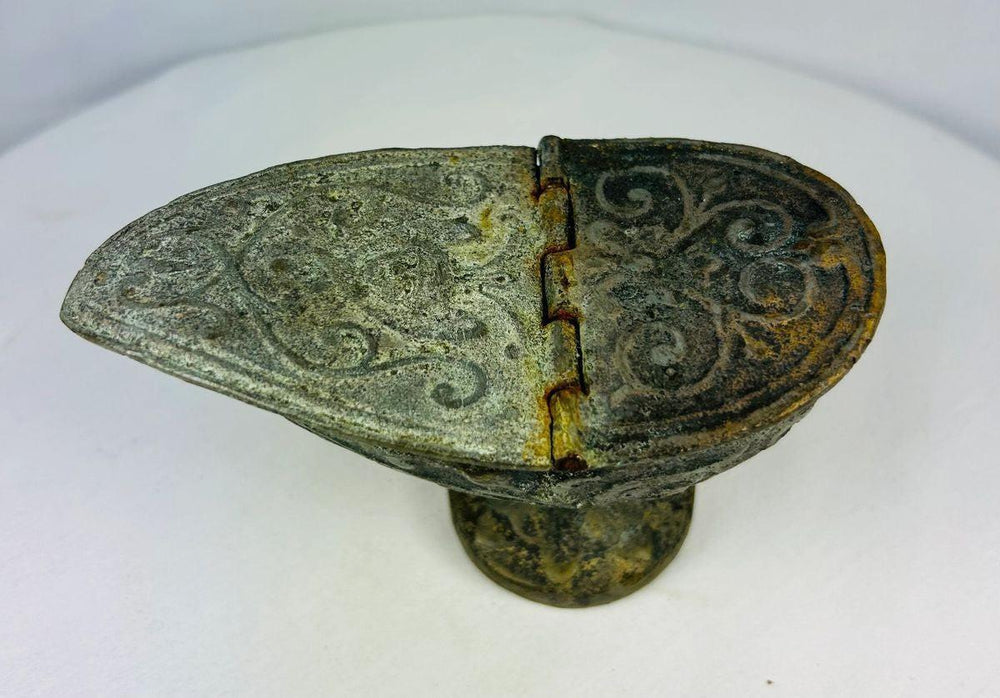 Top view of ancient Chinese bronze oil lamp with hinged lid open, revealing intricate engraved motifs and burial patina.
