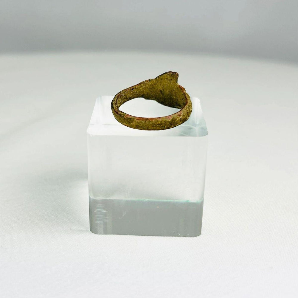 Detail photograph of an early Common Era bronze ring with smooth bezel and oxidized surface