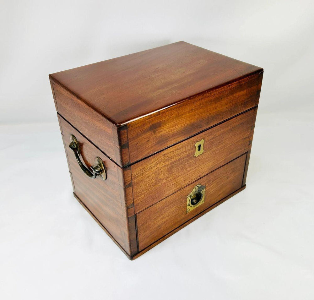 Closed antique Victorian apothecary box made of polished mahogany wood with brass keyholes and fittings, late 19th century chemist’s kit.