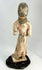 Chinese Tang Dynasty funerary figure showing traditional hairstyle, clasped hands, and elegant drapery