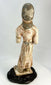 Chinese Tang Dynasty funerary figure showing traditional hairstyle, clasped hands, and elegant drapery