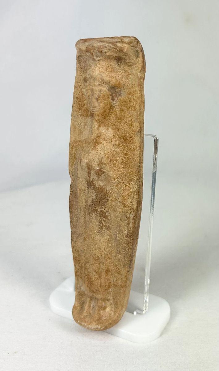 Detail view of faint facial features on a Roman fertility pottery figure