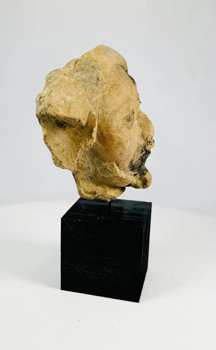 Ancient Mesoamerican ceramic head with expressive facial features