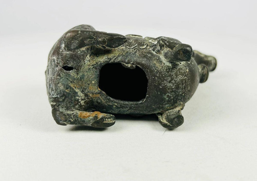 Underside of bronze Qilin censer showing hollow interior, age patina, and wear consistent with ritual incense use.