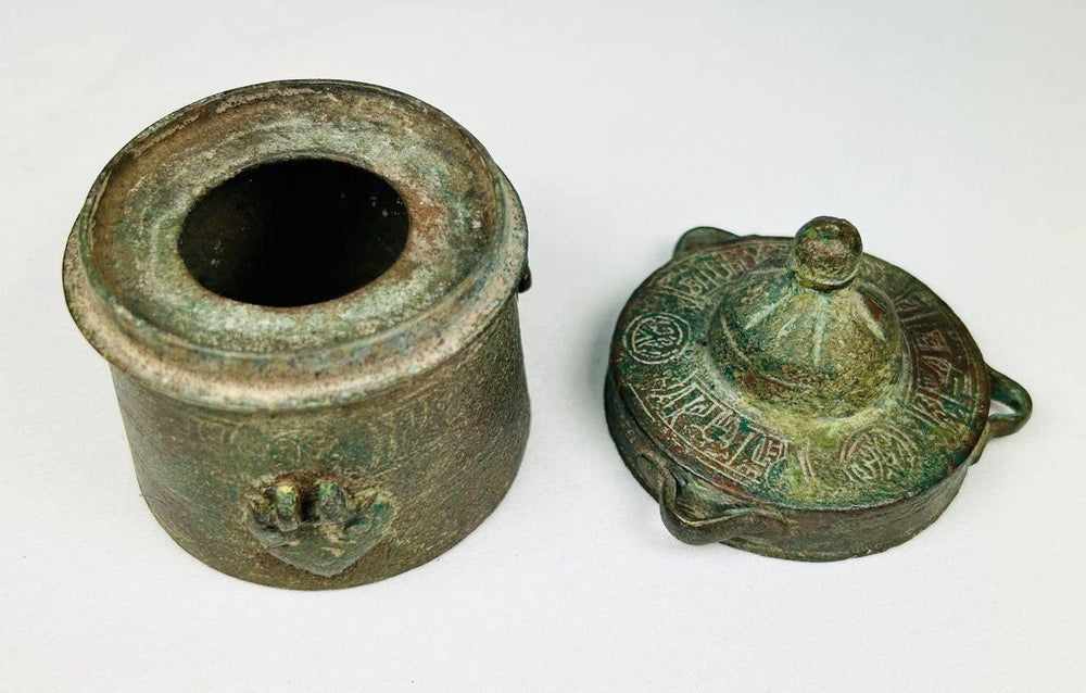 Detailed engraving on the cylindrical body of an Islamic Khorassan bronze inkwell