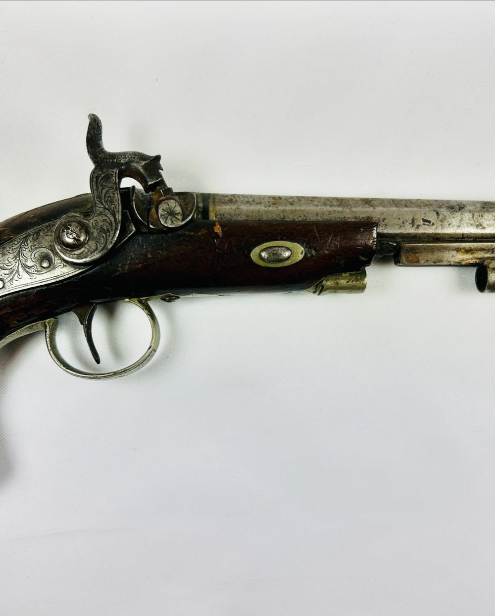 Detailed right-side close-up of Fenton London percussion pistol circa 1780–1830 showing ornate steel lock engraving, double trigger guard, and walnut grip on white background.