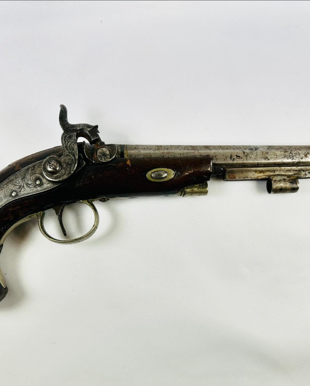 Close-up right-side view of antique Fenton London percussion pistol circa 1780–1830 showing engraved lockplate, hammer detail, and walnut stock on white background.