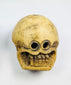 Pair of large 18th–19th century Tibetan Buddhist ritual beads carved from human femur bone, featuring intricate Citipati imagery, vertical suspension holes for stringing, fine patina, and devotional use in meditation on impermanence and mortality