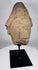 African sculptural stone fragment with conical headdress and solemn expression