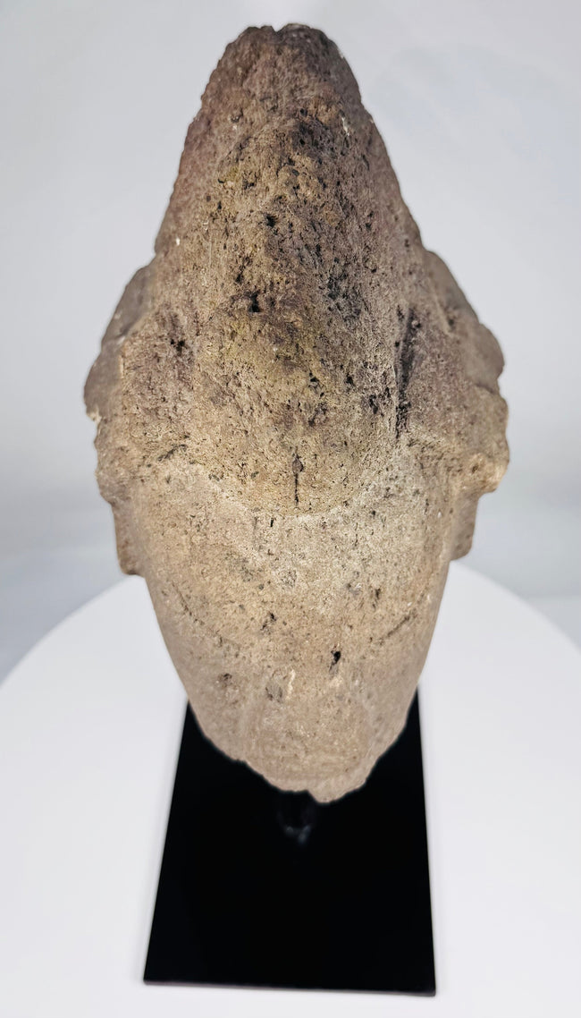 West African-style stone sculpture fragment with prominent brow and compressed lips