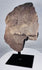African stone head sculpture with recessed eyes, broad nose, and conical coiffure