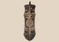African carved wooden ceremonial shield with geometric decoration and central circular medallion