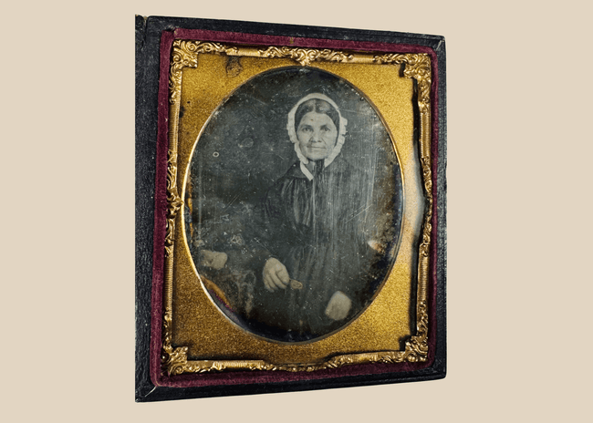 Sixth-plate daguerreotype portrait of a woman wearing a white bonnet and dark dress