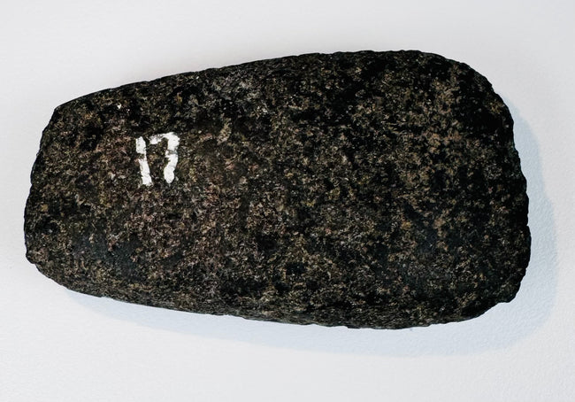 Reverse view of a Pre-Columbian Andean stone axe showing the fully ground face and centuries-old surface patina.