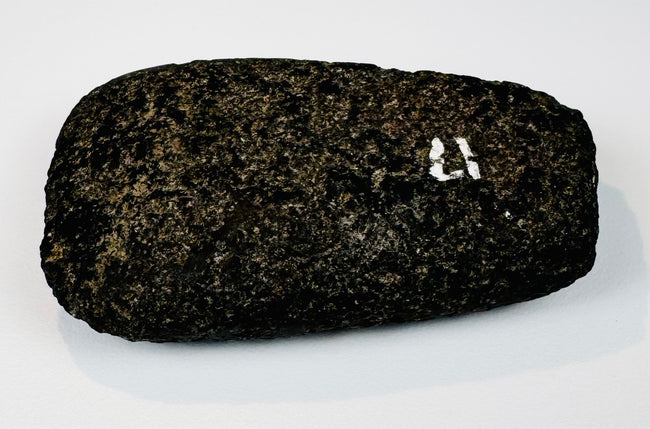 Pre-Columbian Andean ground stone axe from Ecuador or Peru, circa 200–800 CE, showing its broad polished face.