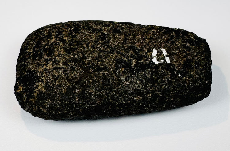 Pre-Columbian Andean ground stone axe from Ecuador or Peru, circa 200–800 CE, showing its broad polished face.