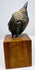 Thai bronze Buddha head with a long earlobe, curved jawline, and raised hair curls, supported above a wooden display base.