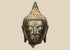Thai bronze Buddha head with half-closed eyes, elongated earlobes, and a pointed topknot against a beige background.