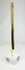 Side view of an ancient Bactrian stone idol with Janus-style human head and elongated form, displayed upright on a modern stand.