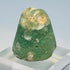 Close-up of ancient glass sealing face with confronted ibex motif