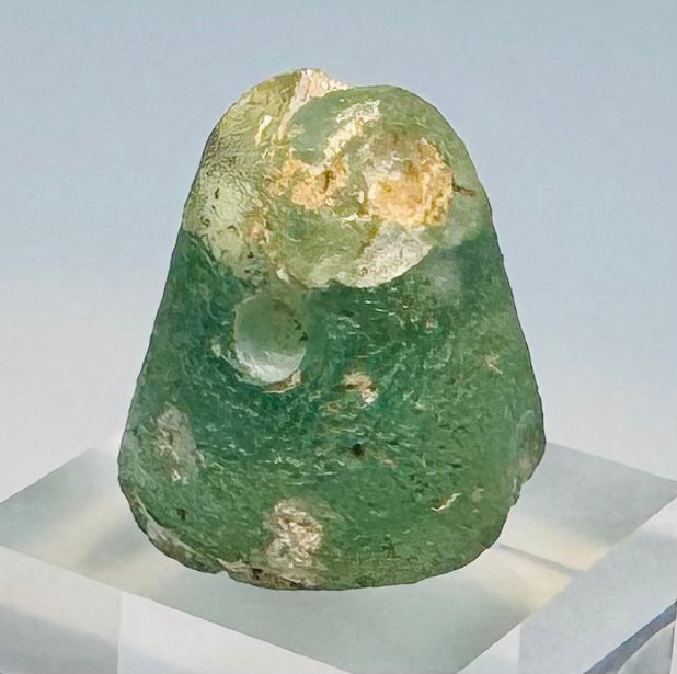 Close-up of ancient glass sealing face with confronted ibex motif
